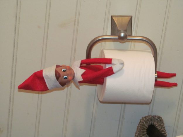 Elf on the Shelf stuck in toilet paper.